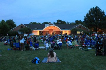 Photo of group watching a performance at the Irwin Park band shell.