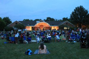 Photo of crowd watching a musical performance at the Irwin Park bandshell.
