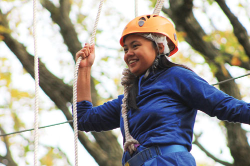 Photo of teen on the high ropes course at Irons Oaks.