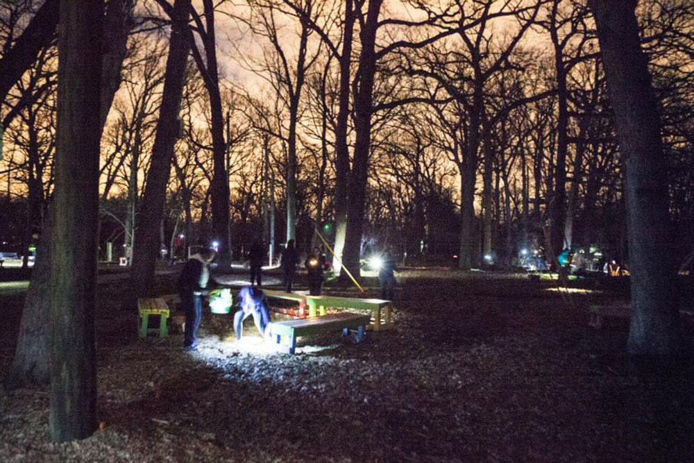 Photo of group searching for eggs at the adult flashlight egg hunt.