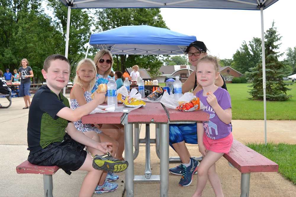 Group photo of family enjoying a meal at the 2018 Hotdog Day.