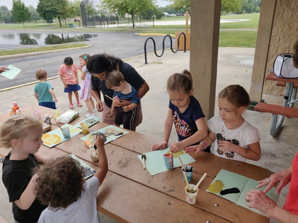 Photo of kids making crafts at the Art in the Park event.