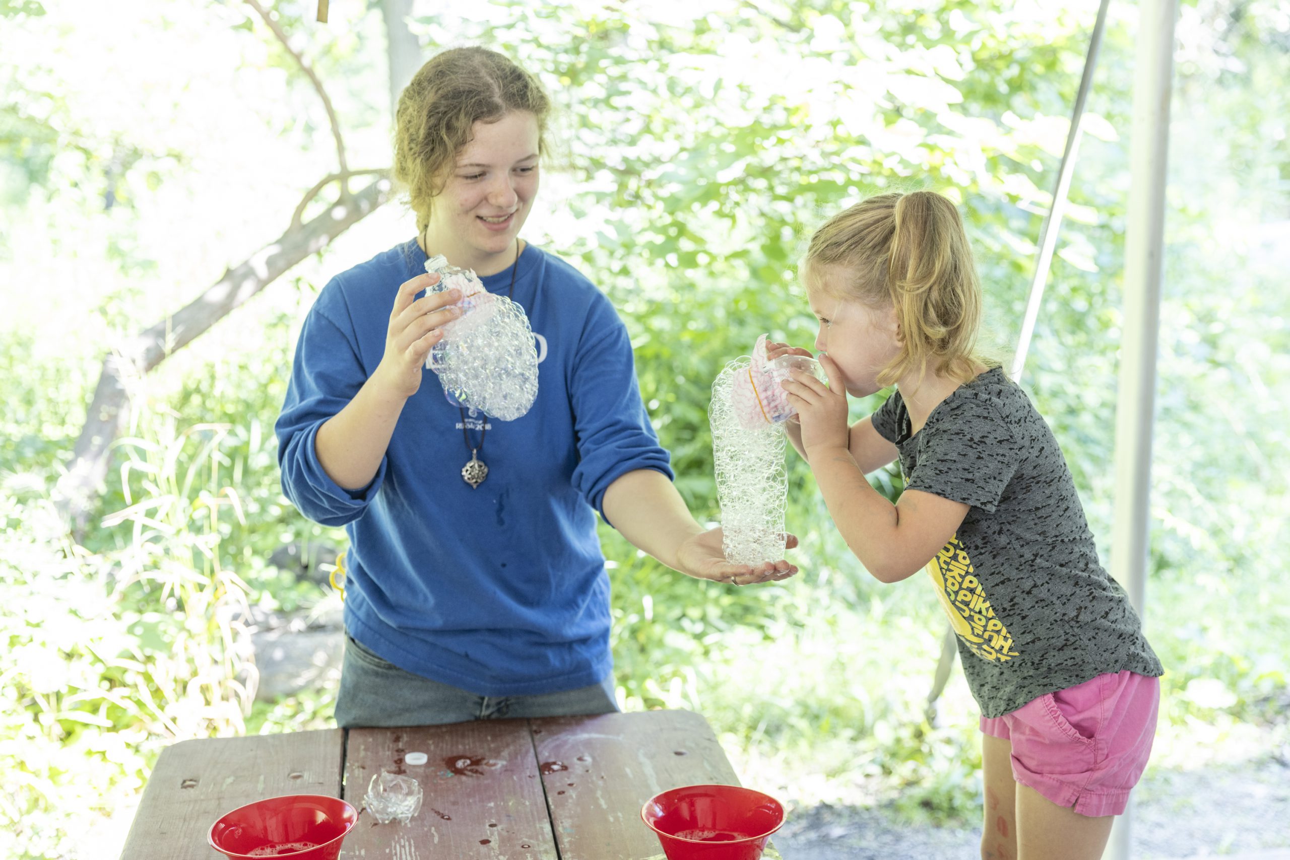 Photo of two people blowing bubble snakes at the Bubble-o-logy event.