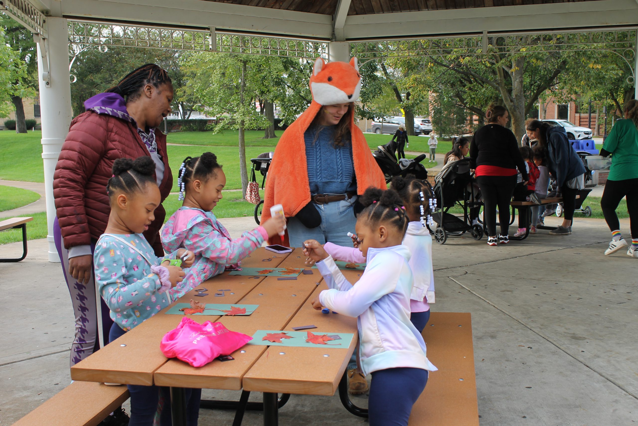 Photo of kids making crafts at the Art in the Park event.
