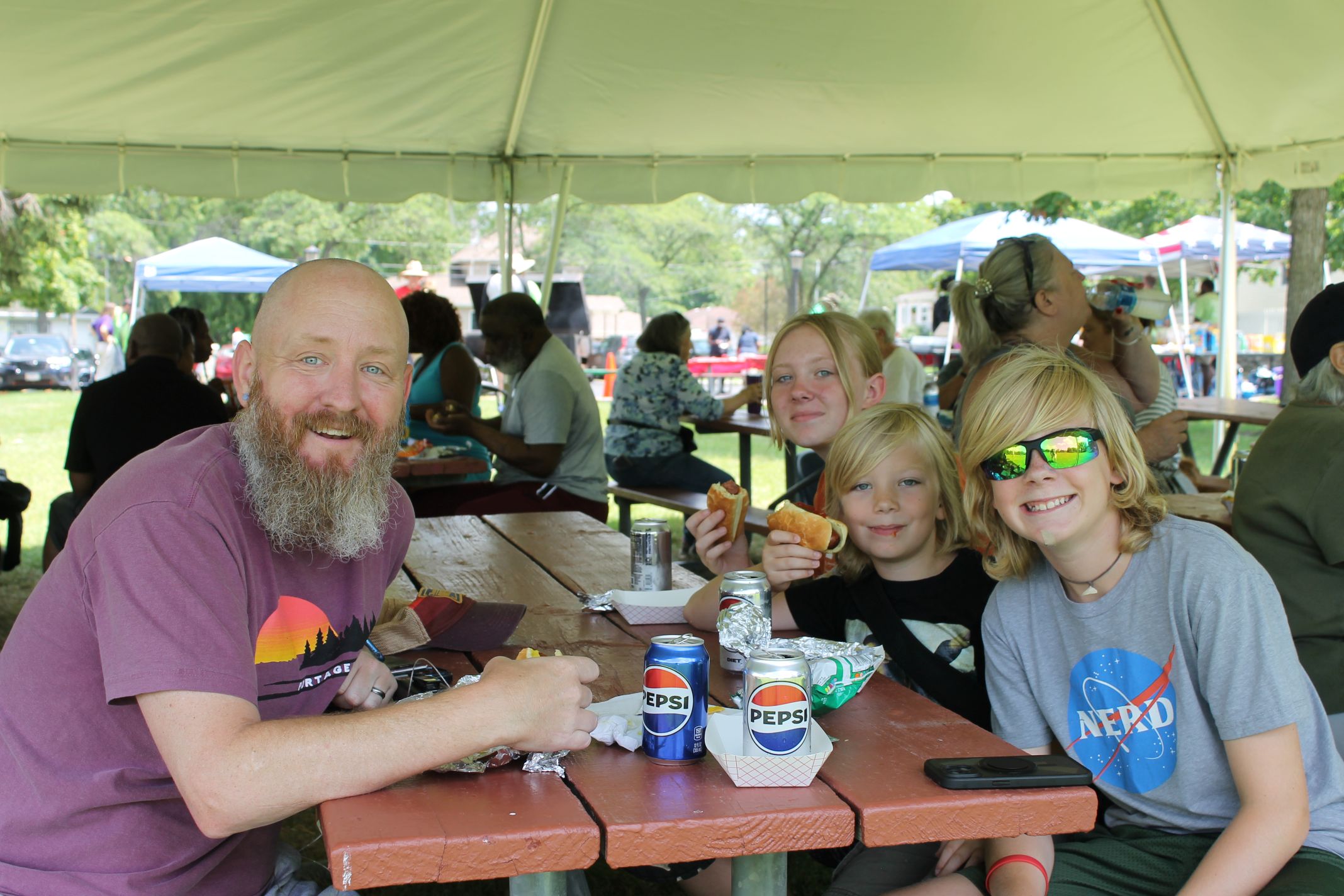 photo of family eating hotdogs