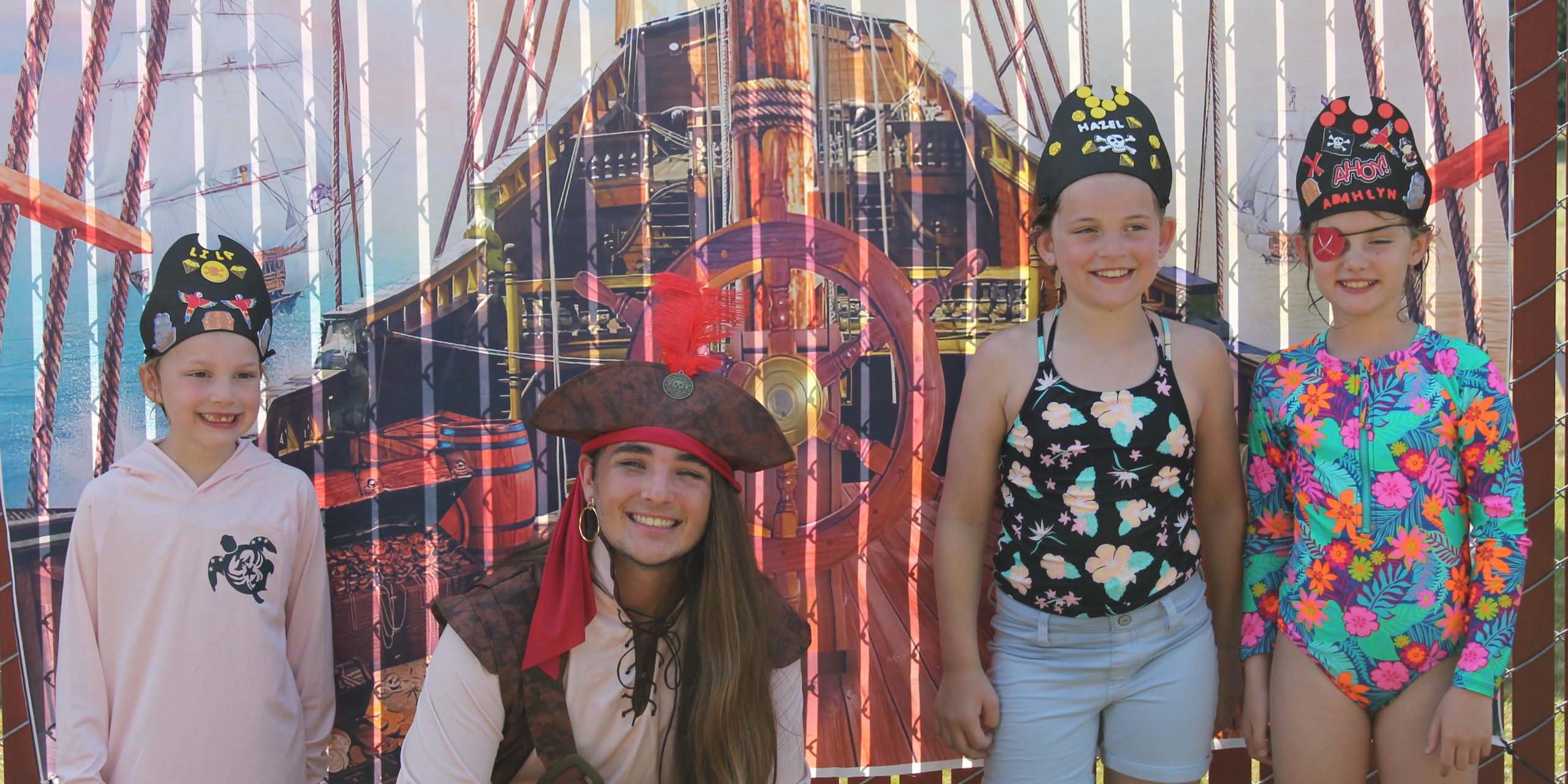 EXPERIENCES21 photo of kids taking a photo with Captain Jack on Pirate Day