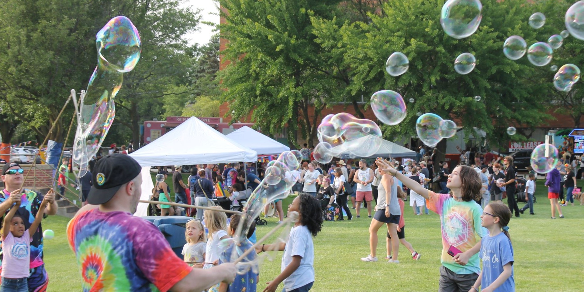 pride bubbels for banner photo of bubble activity and vendor tents at Pride Fest.
