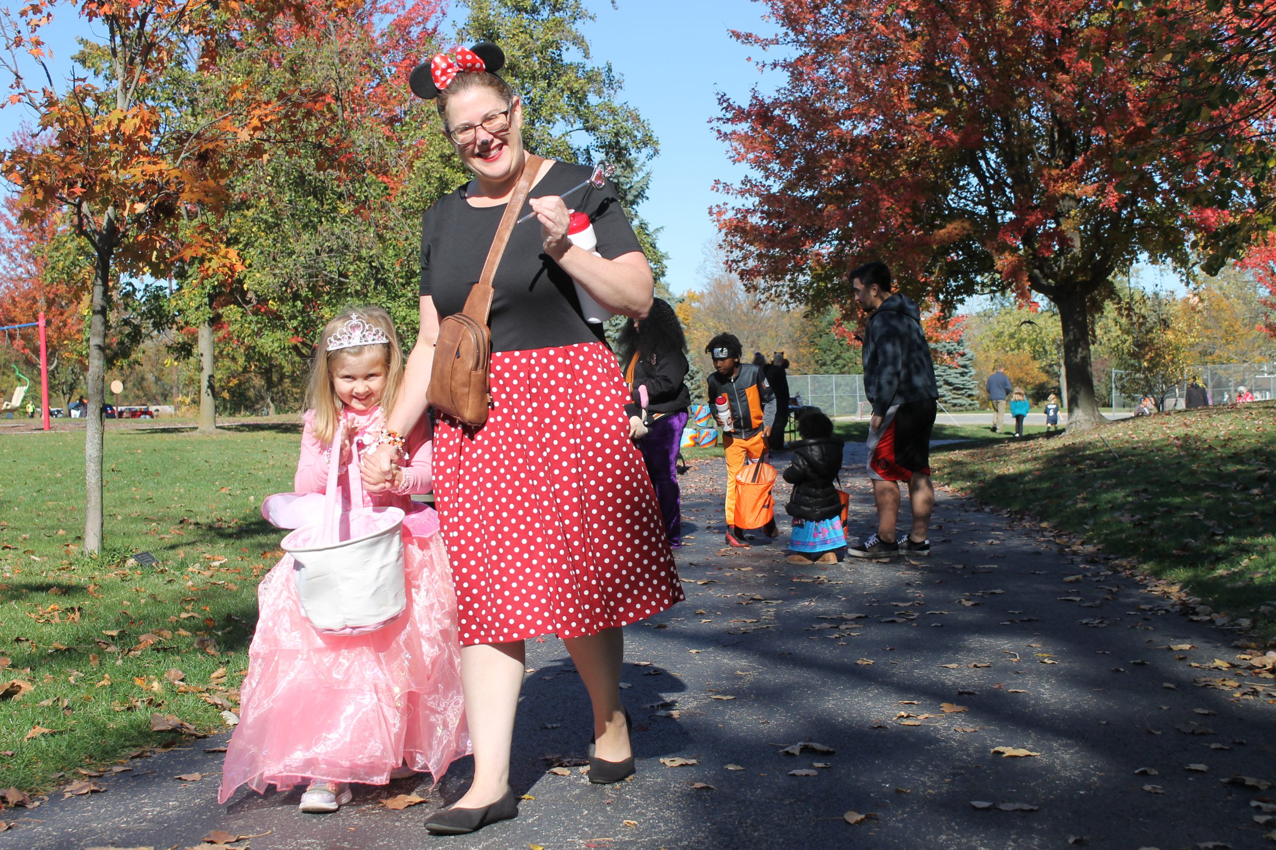 photo of adult and child in costume for the trick or treat trail.