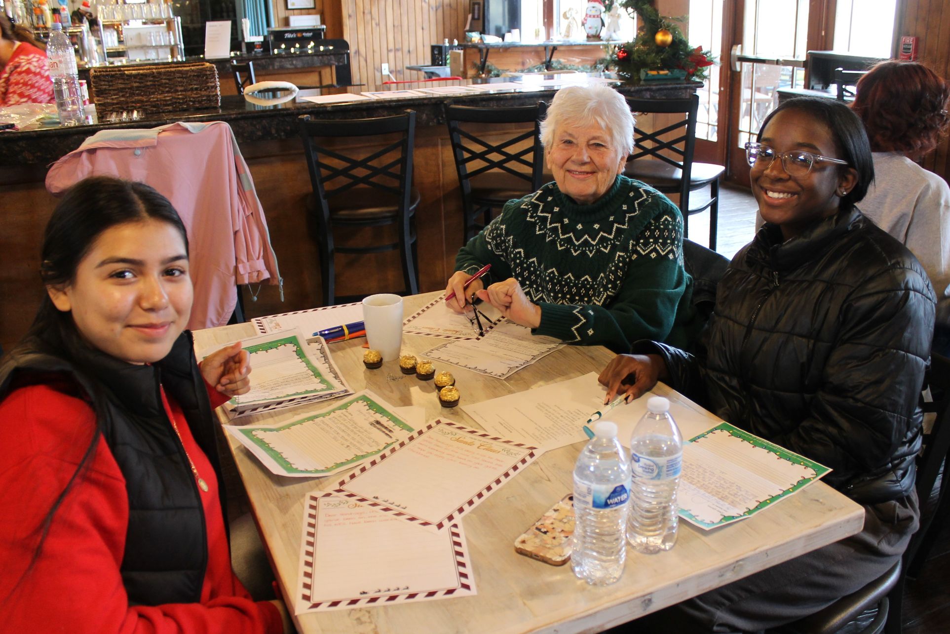 photo of volunteers reading letters to santa