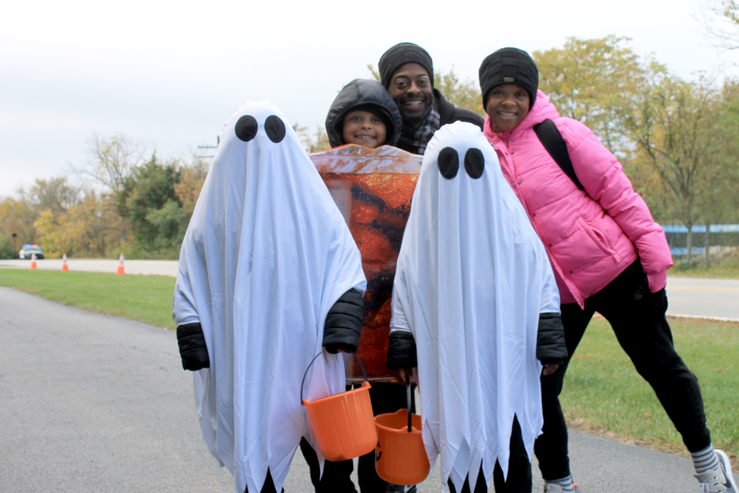 photo of a family in costume at the trick or treat trail