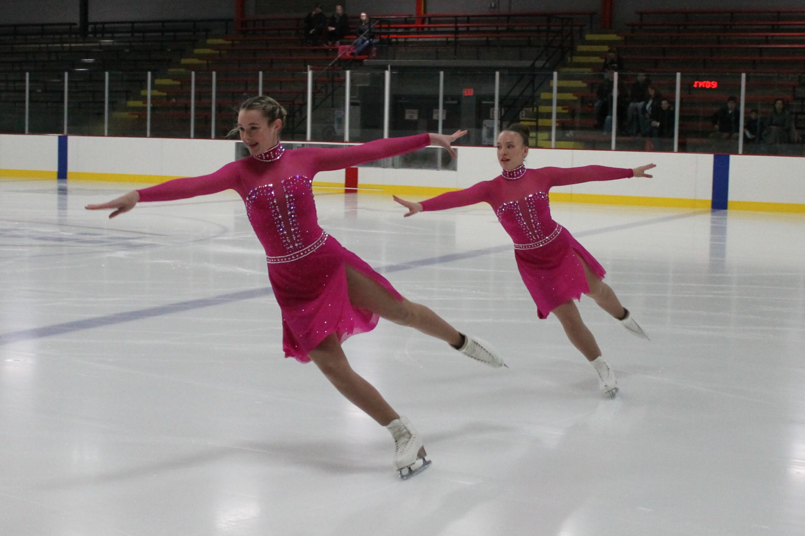 photo of figure skaters skating on the ice